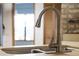 Modern kitchen sink with a sleek faucet and neutral countertops at 9532 Bay Vista Estates Blvd # 1, Orlando, FL 32836
