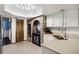 Charming kitchen with brick accent wall, tile floors, and stylish cabinetry at 9532 Bay Vista Estates Blvd # 1, Orlando, FL 32836