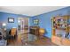 Cozy living room showcasing hardwood floors, blue walls, and stylish furniture at 9532 Bay Vista Estates Blvd # 1, Orlando, FL 32836