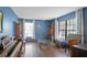 Bright living room featuring hardwood floors, natural light, and blue accent walls at 9532 Bay Vista Estates Blvd # 1, Orlando, FL 32836