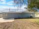 View of the exterior back yard with a screened porch and a patio at 996 E Normandy Blvd, Deltona, FL 32725