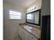 Bathroom features a vanity with granite counters, cabinets, and a framed mirror at 996 E Normandy Blvd, Deltona, FL 32725