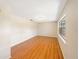 Bright living room featuring wood floors and a large window allowing natural light at 996 E Normandy Blvd, Deltona, FL 32725