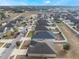 Aerial view of a suburban neighborhood featuring houses with manicured lawns and orderly streetscapes in a planned community at 1230 Woodlark Dr, Haines City, FL 33844