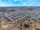 Expansive aerial view of a residential community, showcasing neatly arranged homes in a well-developed suburban setting at 1230 Woodlark Dr, Haines City, FL 33844
