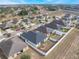 Overhead view of a residential area, displaying homes with fenced backyards and landscaped fronts in a planned community at 1230 Woodlark Dr, Haines City, FL 33844