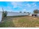 Spacious backyard enclosed by a white fence at 1230 Woodlark Dr, Haines City, FL 33844