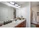 Bathroom featuring a granite countertop vanity, a large mirror and shower with white curtain at 1230 Woodlark Dr, Haines City, FL 33844