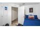 Cozy bedroom with blue bedding and a convenient doorway to another room at 1230 Woodlark Dr, Haines City, FL 33844