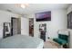 Cozy bedroom with a large TV, stylish decorations, and a comfortable green chair at 1230 Woodlark Dr, Haines City, FL 33844