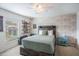 Inviting bedroom with decorative stone accent wall, ceiling fan, and window at 1230 Woodlark Dr, Haines City, FL 33844
