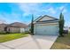 Charming home with a well-manicured front lawn and a two-car garage at 1230 Woodlark Dr, Haines City, FL 33844