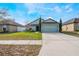 Charming home with a well-manicured front lawn and a spacious driveway at 1230 Woodlark Dr, Haines City, FL 33844