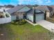 Charming home featuring a two-car garage, well-maintained lawn, and mature landscaping at 1230 Woodlark Dr, Haines City, FL 33844