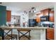 Open kitchen with granite countertops, black appliances, and stylish barstool seating at 1230 Woodlark Dr, Haines City, FL 33844