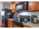 Close-up of kitchen appliances, showing stainless steel microwave and electric stovetop at 1230 Woodlark Dr, Haines City, FL 33844