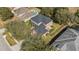 Aerial view of a home with a dark roof, fenced yard, and neighboring house with a pool at 1037 Truffles Ct, Apopka, FL 32712