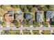 Aerial view of a neighborhood with a street and several homes, two of which have backyard pools at 1037 Truffles Ct, Apopka, FL 32712