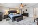 This bedroom features a ceiling fan, a dark wood bed, a gray rug, and a dark wood dresser at 1037 Truffles Ct, Apopka, FL 32712