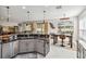 Well-equipped kitchen with granite countertops, stainless appliances, and a view into the dining and living areas at 1037 Truffles Ct, Apopka, FL 32712