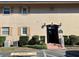 Well maintained condominium exterior with garden area, reserved parking, and secure entrance at 1100 E Caroline St # 119, Tavares, FL 32778