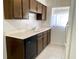 Kitchen featuring traditional cabinets, laminate countertops, and tile flooring at 1100 E Caroline St # 119, Tavares, FL 32778