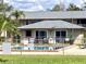 Community pool with a fenced surround and pool-side lounge seating at 1100 E Caroline St # 119, Tavares, FL 32778