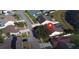 Aerial view of the community, featuring the house with well-kept lawns, trees, and a pond at 12017 Fambridge, Orlando, FL 32837