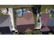 Aerial view of the roof, lawn, and screened pool, surrounded by neighboring houses in the community at 12017 Fambridge, Orlando, FL 32837
