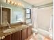 Bathroom with double sinks, granite countertops, bathtub, shower, and neutral walls at 12017 Fambridge, Orlando, FL 32837