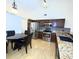 Open kitchen with stainless steel appliances, granite counters, wood cabinets, and a dining area at 12017 Fambridge, Orlando, FL 32837