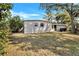 Expansive backyard featuring a well-maintained lawn and mature trees, offering privacy and space at 1202 Ferndell Rd, Orlando, FL 32808