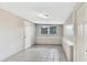 An empty bedroom showcasing light gray tile flooring, window views, and closet space at 1202 Ferndell Rd, Orlando, FL 32808