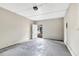 Clean bonus room featuring gray concrete floor, access to yard, and minimal electrical at 1202 Ferndell Rd, Orlando, FL 32808