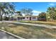 Charming single story home with carport, red front door, and well-maintained lawn at 1202 Ferndell Rd, Orlando, FL 32808