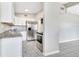 A kitchen showcasing granite countertops, stainless steel appliances, and light gray tile flooring at 1202 Ferndell Rd, Orlando, FL 32808