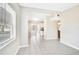 Bright living room showcasing a large window, tile floors, and an open floor plan to the kitchen and beyond at 1202 Ferndell Rd, Orlando, FL 32808