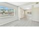 Bright living room with large windows, tiled flooring, and an open doorway at 1202 Ferndell Rd, Orlando, FL 32808