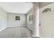 Open living room space with tiled floor and bright natural light from large windows at 1202 Ferndell Rd, Orlando, FL 32808