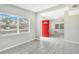 Bright and airy living room featuring tile floors and a vibrant red front door at 1202 Ferndell Rd, Orlando, FL 32808