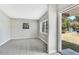 Clean, well-lit living room with tiled floor and door to the outside at 1202 Ferndell Rd, Orlando, FL 32808