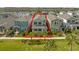 Aerial view highlighting a two-story home with lush landscaping and a sidewalk, all outlined in red at 12051 Walmsley Aly, Winter Garden, FL 34787