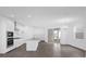 Bright and airy living room opens to the kitchen, showcasing modern finishes and wood floors at 12051 Walmsley Aly, Winter Garden, FL 34787