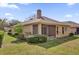 Exterior view of home with a screened patio and well-maintained lawn at 1314 Chessington Cir, Lake Mary, FL 32746