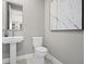 Bathroom features a pedestal sink, toilet, and modern decor at 13154 Pergola Ave, Orlando, FL 32832