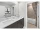 Bathroom featuring double sinks, a large mirror, and a combined shower and tub at 13154 Pergola Ave, Orlando, FL 32832