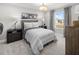This bedroom offers a cozy retreat with neutral tones and a large window at 13154 Pergola Ave, Orlando, FL 32832