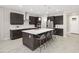 Spacious kitchen featuring a central island with seating, stainless steel appliances, and modern finishes at 13154 Pergola Ave, Orlando, FL 32832