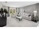 Comfortable living room features a large sectional sofa, stylish décor, and bright natural light at 13154 Pergola Ave, Orlando, FL 32832