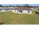 The backyard features lush green grass, while the home has a brown roof and multiple windows at 15240 Sw 43Rd Ct, Ocala, FL 34473